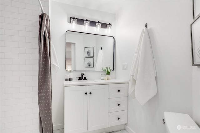 bathroom with walk in shower and vanity