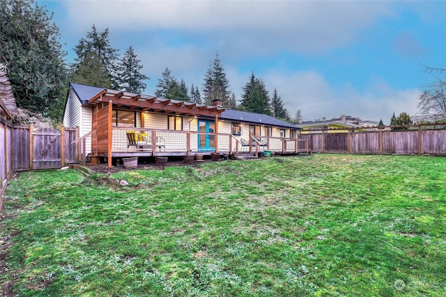 back of property with a yard and a wooden deck