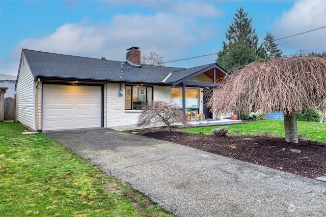 single story home featuring a front yard and a garage