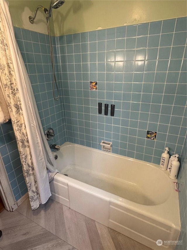 bathroom featuring tile patterned flooring and shower / tub combo