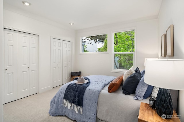 carpeted bedroom with multiple closets