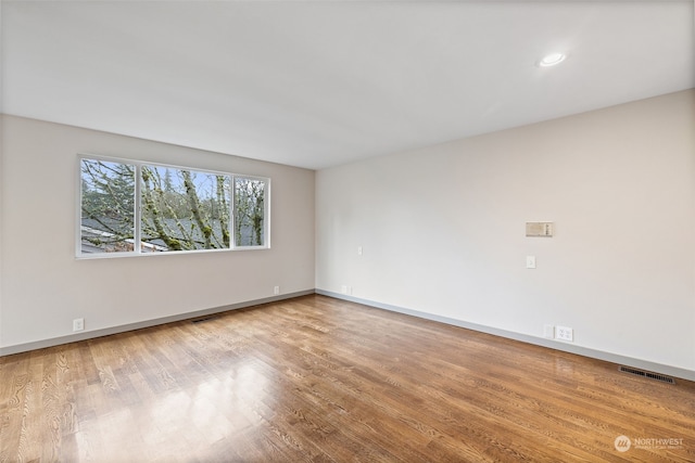 unfurnished room featuring hardwood / wood-style flooring