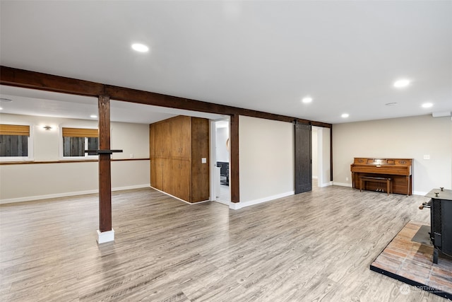 basement featuring a wood stove and hardwood / wood-style flooring