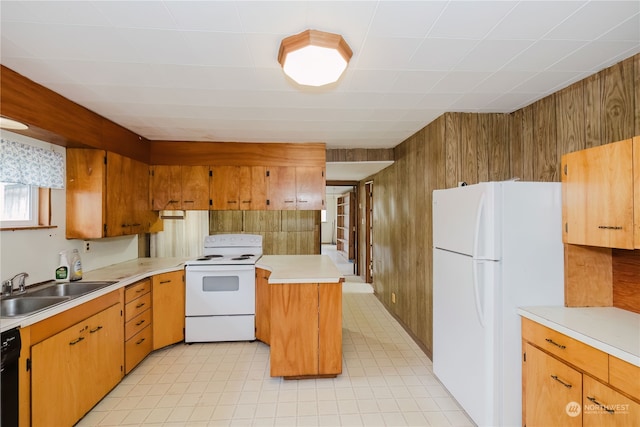 kitchen featuring white appliances, wooden walls, and sink