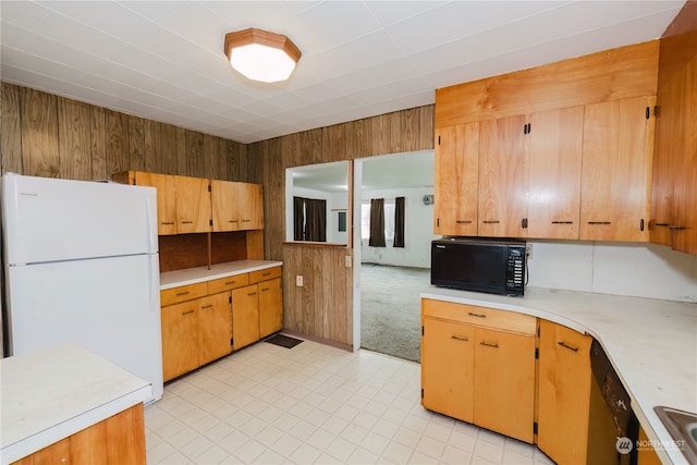 kitchen with wooden walls and black appliances