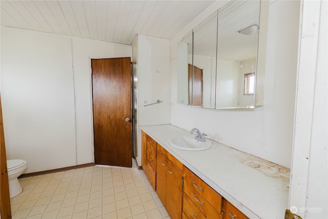 bathroom featuring toilet and vanity