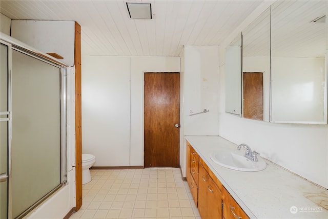 full bathroom featuring toilet, bath / shower combo with glass door, and vanity