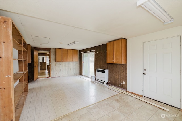 kitchen featuring wooden walls and heating unit