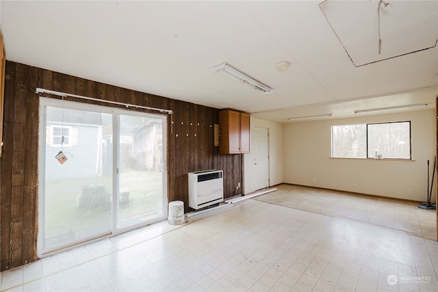 interior space featuring wood walls and heating unit