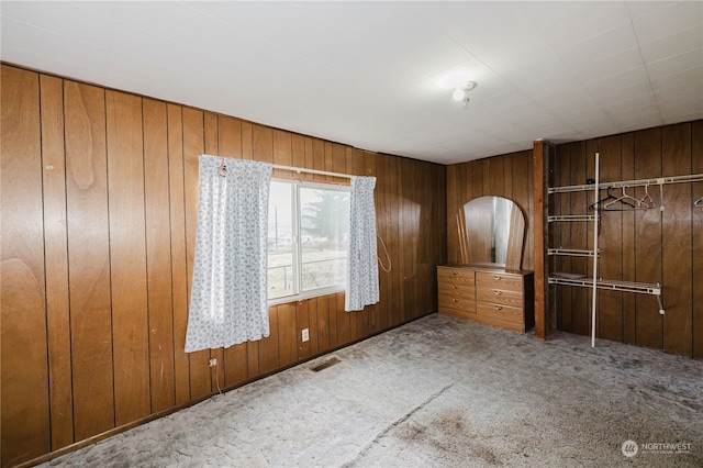 interior space with wooden walls and carpet