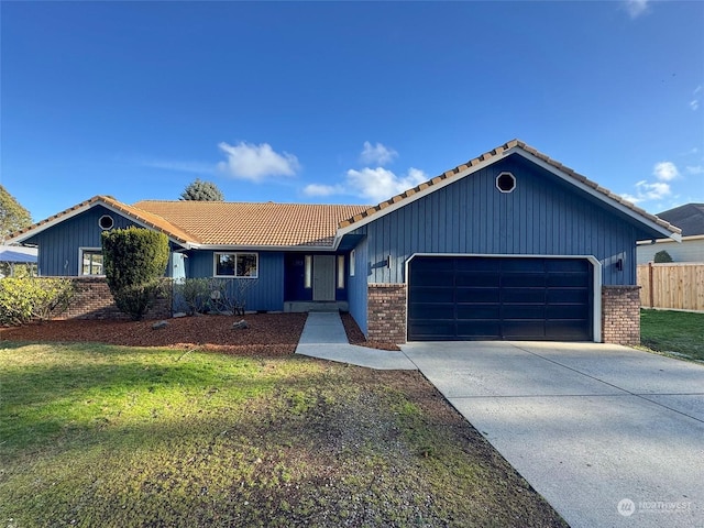 ranch-style home featuring a garage and a front yard