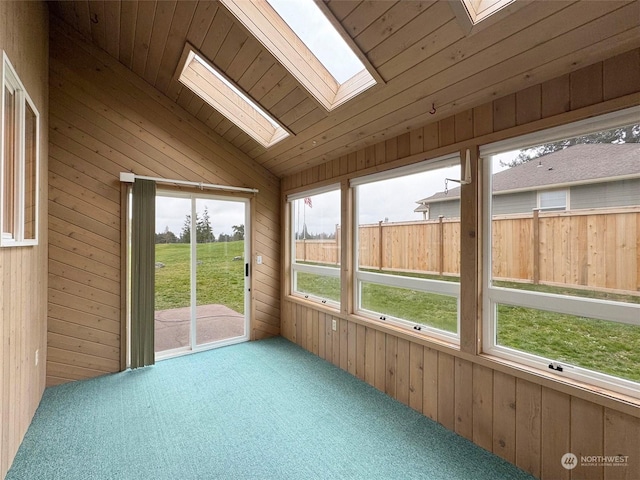 unfurnished sunroom featuring wood ceiling and vaulted ceiling with skylight