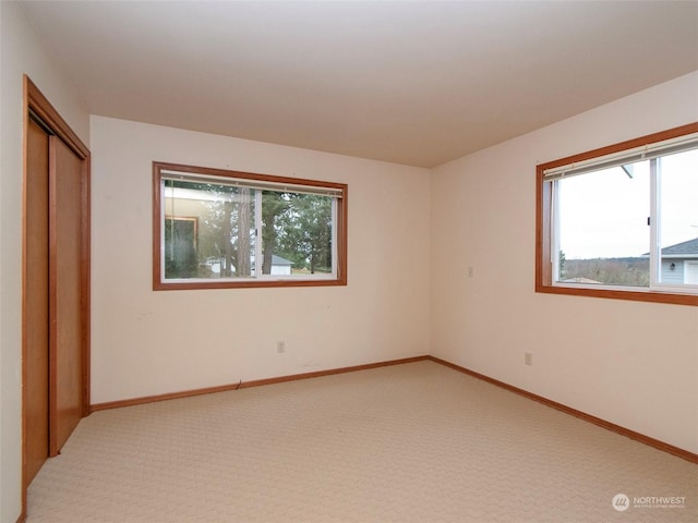 unfurnished bedroom featuring carpet floors and a closet