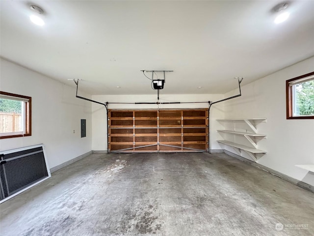 garage with a garage door opener and electric panel