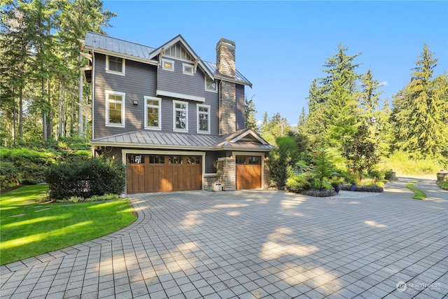 view of front of property with a front lawn and a garage