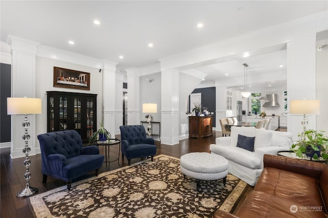 living room with crown molding and dark wood-type flooring