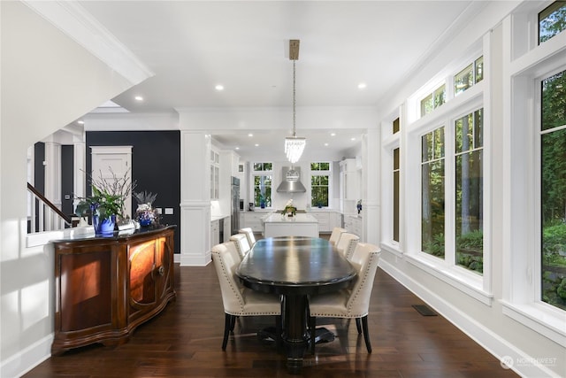 dining space with a healthy amount of sunlight, dark hardwood / wood-style flooring, and crown molding