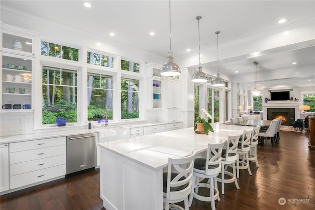 kitchen featuring a kitchen island, dishwasher, and decorative backsplash