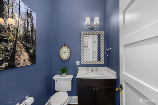 bathroom featuring toilet and vanity