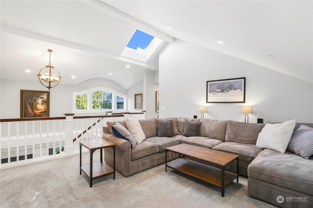 living room with light colored carpet, a chandelier, and vaulted ceiling with skylight