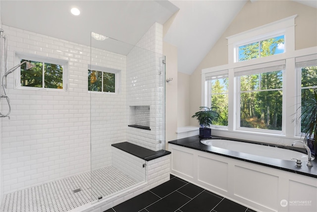 bathroom with lofted ceiling, tile patterned floors, and plus walk in shower