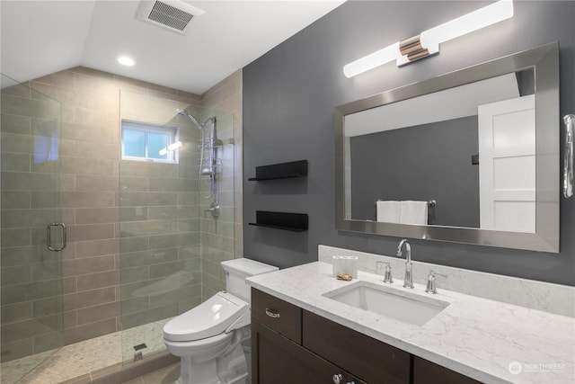 bathroom with vaulted ceiling, toilet, vanity, and a shower with shower door