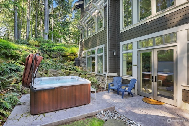 view of patio / terrace featuring french doors and a hot tub