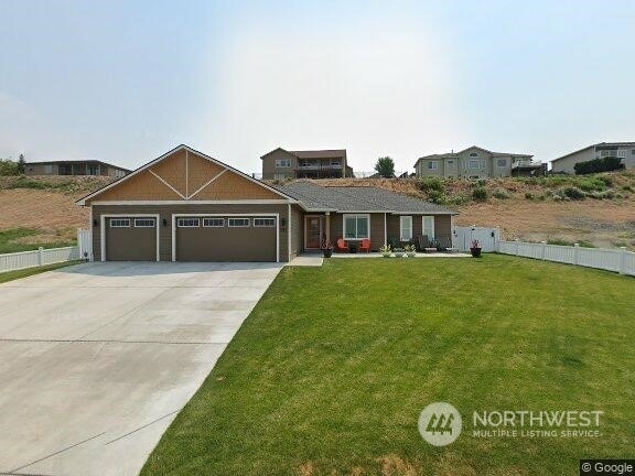 view of front of house with a garage and a front lawn