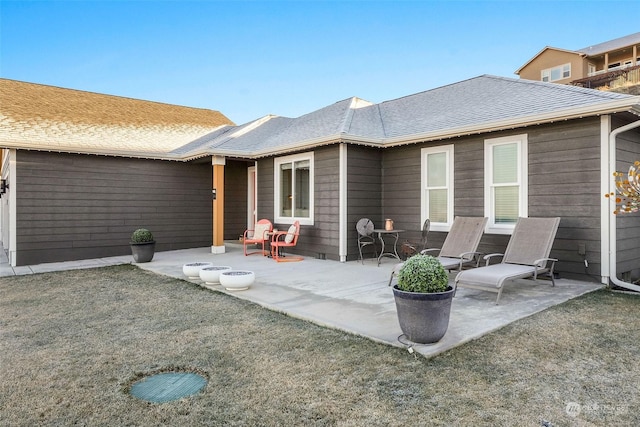 back of house with a patio and a yard