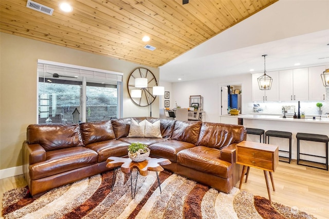 living room with wood ceiling, lofted ceiling, and light wood-type flooring