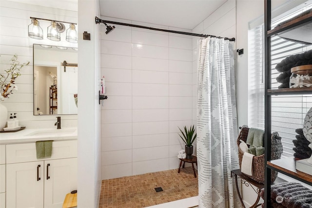 bathroom featuring a shower with curtain, tile patterned floors, and vanity