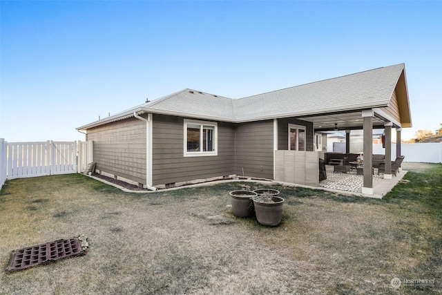 rear view of property featuring a yard and a patio