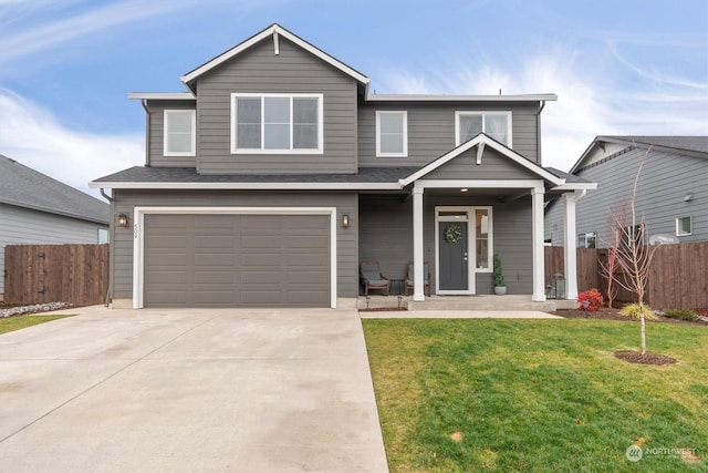 view of front of property with a front yard and a garage