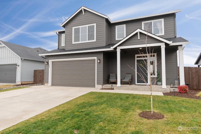 view of front of property with a garage, a porch, and a front lawn