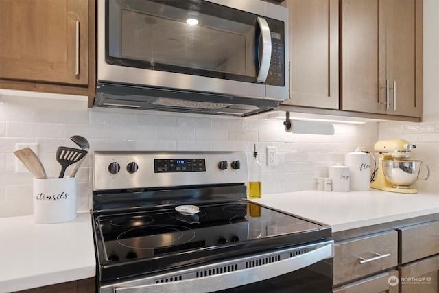 kitchen featuring appliances with stainless steel finishes and decorative backsplash