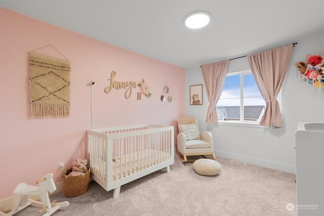 carpeted bedroom featuring a crib