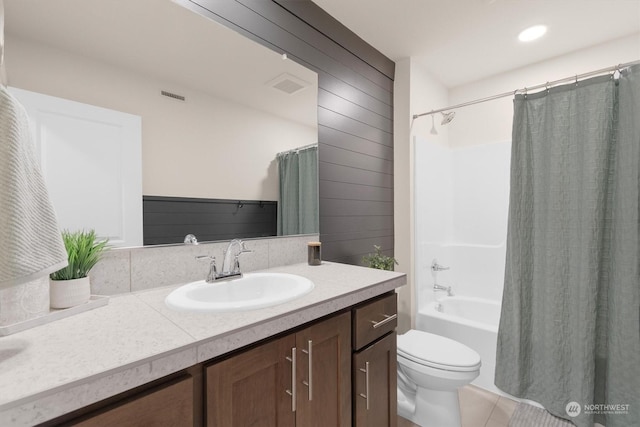 full bathroom with shower / tub combo, vanity, tile patterned floors, and toilet