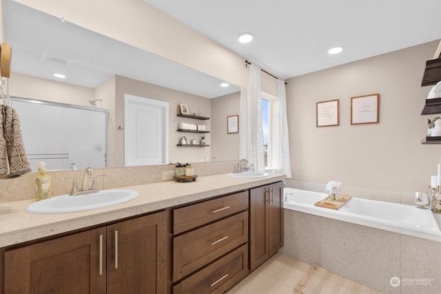 bathroom with tile patterned flooring, vanity, and shower with separate bathtub