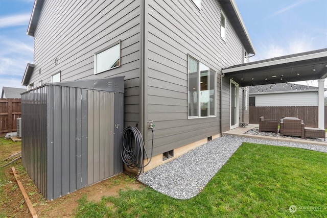 view of home's exterior with a lawn and an outdoor living space