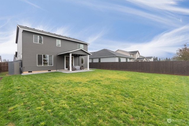 back of property with a patio area and a yard