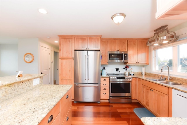 kitchen with light stone countertops, sink, stainless steel appliances, dark hardwood / wood-style flooring, and light brown cabinets