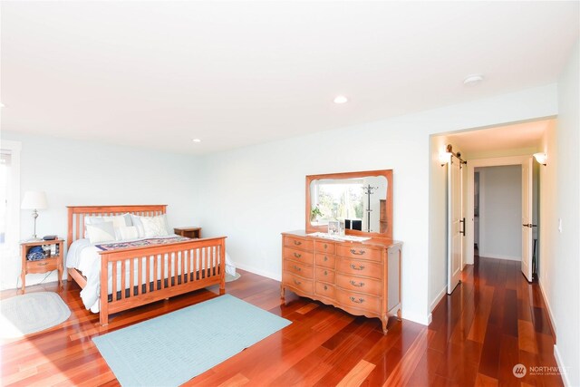 bedroom with dark hardwood / wood-style flooring