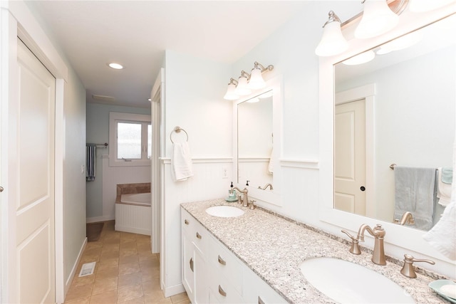 bathroom featuring a bathtub, tile patterned floors, and vanity