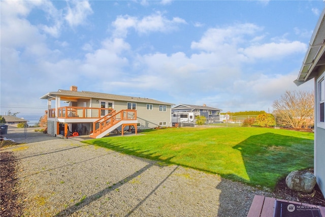 back of house with a deck and a yard