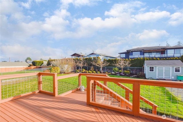 wooden terrace with a yard and a storage unit