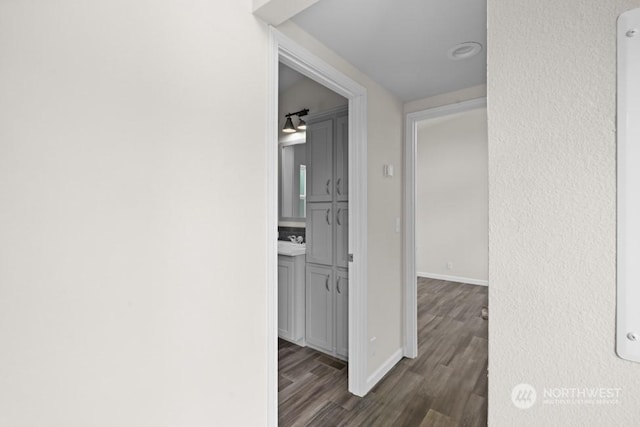 hallway with dark hardwood / wood-style floors and sink