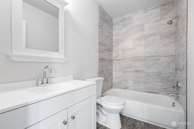 full bathroom with vanity, hardwood / wood-style flooring, tiled shower / bath combo, and toilet