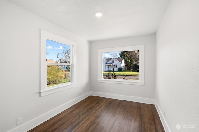 spare room featuring dark hardwood / wood-style flooring