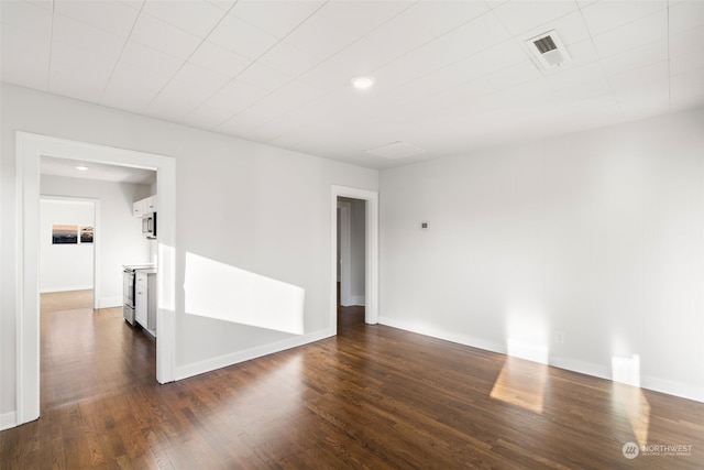 empty room with dark wood-type flooring