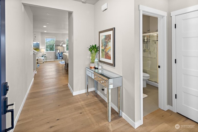 corridor with light hardwood / wood-style floors